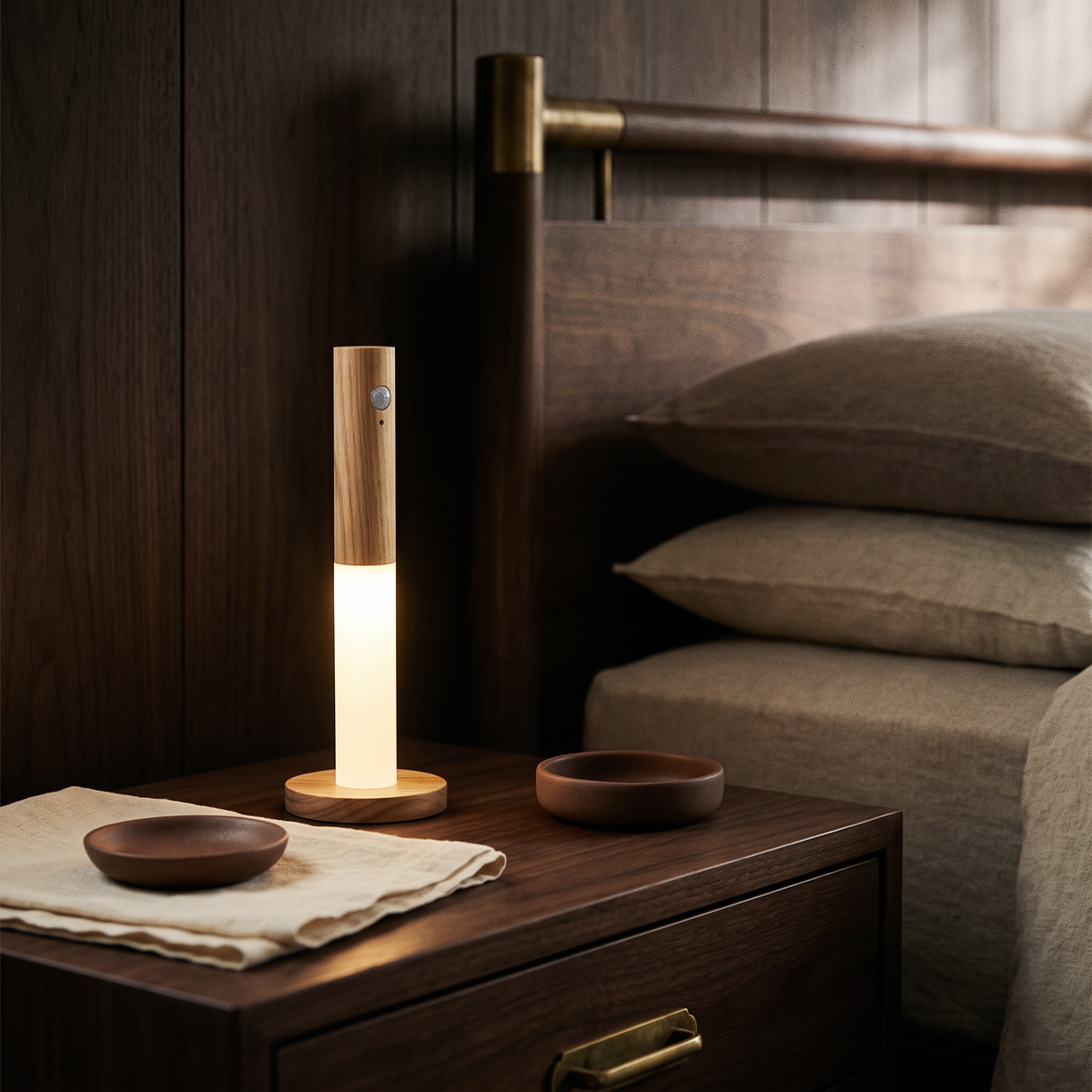 Night light standing freestanding on a walnut bedside table