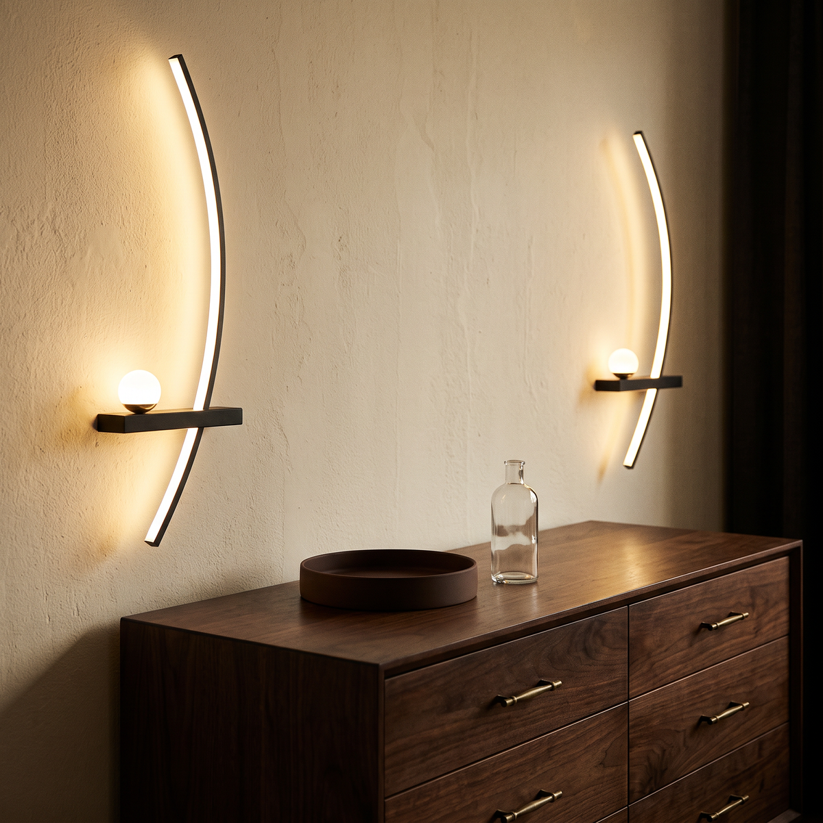 Two crescent lamps flanking a dark walnut dresser in a dressing area