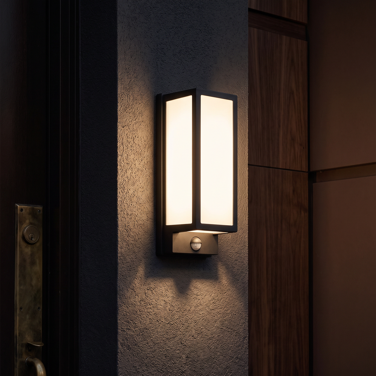 The upright lantern glowing on a rendered wall with light washing around it